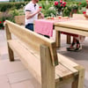 Elegant outdoor wooden dining table with matching benches in a lush garden setting, perfect for al fresco meals and gatherings.