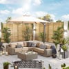 Cozy outdoor patio lounge with beige sectional sofa, decorative cushions, large beige umbrella, modern lanterns, and lush greenery, perfect for relaxation and entertaining in a stylish backyard setting.
