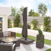 Contemporary outdoor patio with firepit, sectional sofa, large umbrella, lush plants, and privacy fencing, perfect for home and garden entertaining and relaxation.