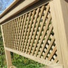 Natural wood lattice panel for garden or outdoor decor, perfect for privacy and aesthetic enhancement.