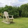 Aesthetic wooden garden rocker chair surrounded by lush green bushes and vibrant flower garden on a bright, cloudy day. Perfect for outdoor relaxation and garden furniture.