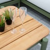 Modern outdoor patio table with potted succulents, glassware, and decorative lantern for stylish garden and home entertaining.