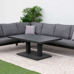 Modern outdoor sectional sofa with gray cushions and black metal frame, perfect for patio or garden lounging. Features stylish throw pillows and a matching coffee table for a contemporary backyard setup.