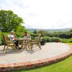 Relaxing outdoor patio with wooden furniture and lush garden views, ideal for outdoor dining and entertaining. Perfect backyard space for family gatherings and enjoying nature in a peaceful setting.