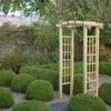 Lush garden with decorative topiary and a wooden garden arbor, perfect for outdoor relaxation and garden enhancement.