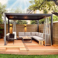 Stylish outdoor patio with a modern gazebo, cozy sectional sofa, patio heater, and wooden deck, perfect for relaxing or entertaining in a backyard garden setting.