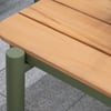 Sleek outdoor wooden garden bench with green metal frame, stylish design, perfect for backyard relaxation.