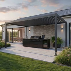 Outdoor kitchen with built-in grill and modern black cabinetry under a stylish metal pergola, surrounded by lush landscaping, ideal for outdoor entertaining and backyard upgrades.