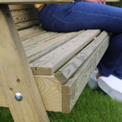 Roughly textured wooden garden bench built with pressure-treated lumber, ideal for outdoor home and garden relaxation. Durable wood construction designed for outdoor furniture use.