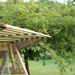 Natural wooden outdoor playground equipment, ideal for kids' playsets, in a lush green backyard setting. Perfect for family outdoor fun and summer recreation.