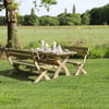 Rustic outdoor dining table set at a scenic garden with lush greenery and open fields in the background, perfect for garden furniture and outdoor entertaining.