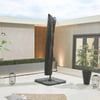 Modern outdoor patio featuring a black umbrella, potted plants, lanterns, and contemporary decor, ideal for outdoor living, landscaping, and garden design with stylish accents from Empire Home and Garden.