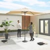 Relaxing outdoor patio with beige umbrella, modern decor, and lush green plants, perfect for entertaining guests and enjoying outdoor living; stylish backyard furniture and ambiance.
