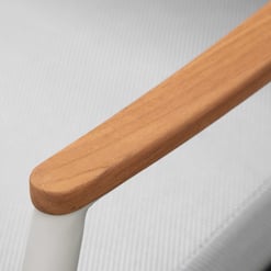 Natural wood and white metal handrail component of modern outdoor furniture.