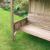 Beautiful wooden garden bench under a shelter in a lush backyard garden, perfect for outdoor relaxation and enhancing your landscaping with stylish, durable outdoor furniture.