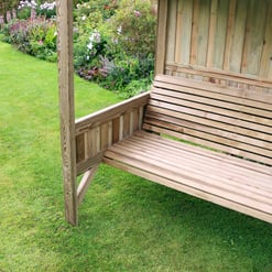 Beautiful wooden garden bench under a shelter in a lush backyard garden, perfect for outdoor relaxation and enhancing your landscaping with stylish, durable outdoor furniture.