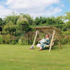 Relaxing garden swing for outdoor leisure with lush greenery and colorful flowers, perfect for enjoying peaceful moments in the yard.