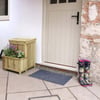 Bright front door entrance with a cozy outdoor decor, wooden planter with colorful flowers, and floral rain boots, showcasing stylish home and garden design elements.