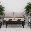 Elegant outdoor patio furniture set featuring cushioned chairs and a sofa, accented by vibrant flowering plants and modern decor, perfect for garden and backyard entertaining.
