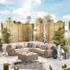Stylish outdoor patio with beige sectional sofa, decorative pillows, modern lanterns, lush greenery, and privacy wooden fencing, perfect for outdoor entertaining and relaxation.