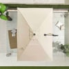 Portable beige patio umbrella with stand and outdoor decor on balcony with plants and cushions at Empire Home and Garden.