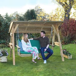 Stylish wooden outdoor swing with canopy in a lush garden, perfect for relaxing and entertaining, surrounded by vibrant plants and flowers.