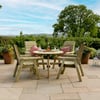 Natural outdoor patio dining space with wooden chairs, potted plants, and scenic countryside views; perfect for al fresco meals and relaxing in a garden oasis.