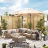 Contemporary outdoor patio furniture with beige sectional sofa, a large beige patio umbrella, surrounded by lush green plants, perfect for outdoor living and entertaining.