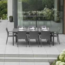 Stylish outdoor dining table with six chairs on a modern patio, ideal for entertaining in a contemporary home garden.