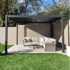 Modern outdoor living space with a stylish shade structure, comfortable sectional sofa, and private backyard setting for outdoor relaxation and entertainment.