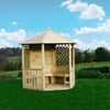 Wooden garden gazebo with lattice sides and a shingled roof on lush green lawn, perfect for outdoor relaxation and entertaining.