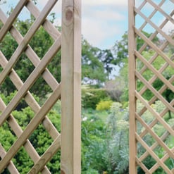 Lattice garden trellises for outdoor landscaping and plant support, made of natural wood, enhancing garden aesthetics and functionality. Perfect for supporting climbing plants and creating a charming garden space.