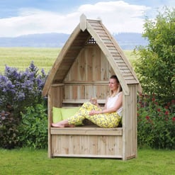 Big wooden outdoor garden nook for relaxing with a view, surrounded by lush plants and flowers. Perfect for outdoor leisure and enjoying nature in your backyard or garden space.