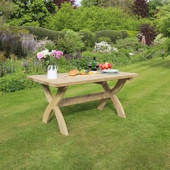 Vibrant garden with outdoor dining table featuring fresh food and drinks, surrounded by lush greenery, blooming flowers, and scenic landscape, perfect for garden entertaining and outdoor meals.