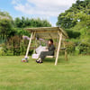 Relaxing garden swing with a woman enjoying the outdoors, surrounded by lush greenery and colorful flowers, ideal for outdoor furniture and garden decor.