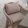 Elegant outdoor wicker armchair with beige cushions for patio or garden decor. Perfect for comfortable lounging and enhancing outdoor living spaces. Sturdy wooden frame and woven design.