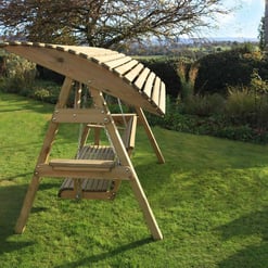 Natural wooden outdoor garden swing set in a lush green backyard, perfect for children’s play. Ideal for enhancing outdoor spaces with quality garden furniture and play equipment.
