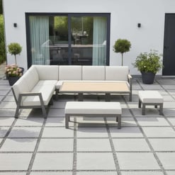Stylish outdoor patio furniture set with modern beige cushioned seating, wood and metal accents, surrounded by potted plants on a sleek tiled terrace for a comfortable garden entertaining space.