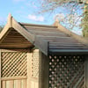 Solid wooden garden shed with lattice design and pitched roof, ideal for outdoor storage and gardening needs. Made from durable, natural wood for garden enthusiasts.