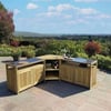 Outdoor wooden bar cart with glassware and wine bottles on a patio overlooking a lush garden and rolling hills, perfect for outdoor entertaining and garden decor.