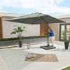 Relaxing outdoor patio with large adjustable umbrella, potted plants, cozy rug, and decorative lanterns, perfect for backyard entertaining and outdoor living.