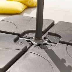 Metal outdoor patio umbrella base with adjustable weight plates, ideal for garden and outdoor furniture stability.