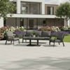 Modern outdoor patio furniture set on a spacious tile patio with lush garden and contemporary architecture, perfect for relaxing in a stylish garden or backyard space.