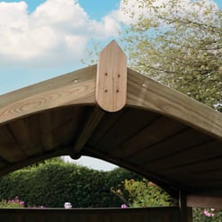 Beautiful wooden garden arbor with curved roof, perfect for outdoor relaxation and garden decor at Empire Home and Garden. Crafted with durable, natural wood for long-lasting outdoor use.