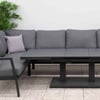 Modern outdoor sectional sofa with adjustable black dining table, weather-resistant cushions, and surrounding greenery for stylish garden or patio entertainment.