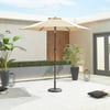 Elegant outdoor patio with a large beige umbrella, modern potted plants, and decorative accents, perfect for outdoor living and entertaining in a contemporary home setting.