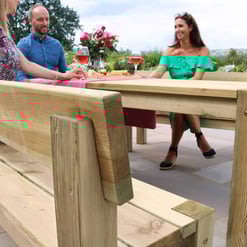 Natural wood outdoor dining table set at Empire Home and Garden, perfect for entertaining guests with a stylish and durable patio furniture solution.