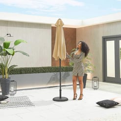 Modern outdoor patio with stylish umbrella, potted plants, and cozy seating area at Empire Home and Garden. Perfect for relaxing or entertaining in a beautifully designed outdoor space.