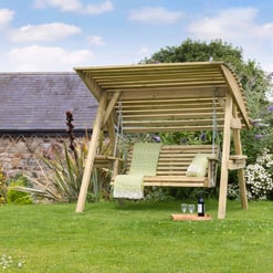Relaxing wooden garden swing with canopy in lush backyard surrounded by colorful flowers and greenery, perfect for outdoor relaxation and garden decor.