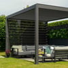 Modern outdoor pergola with comfortable patio furniture and lush greenery for stylish backyard entertainment and garden relaxation.